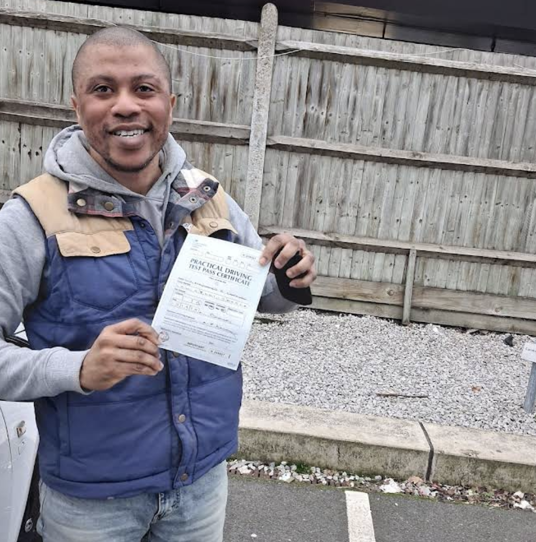 Student with pass certificate at test centre