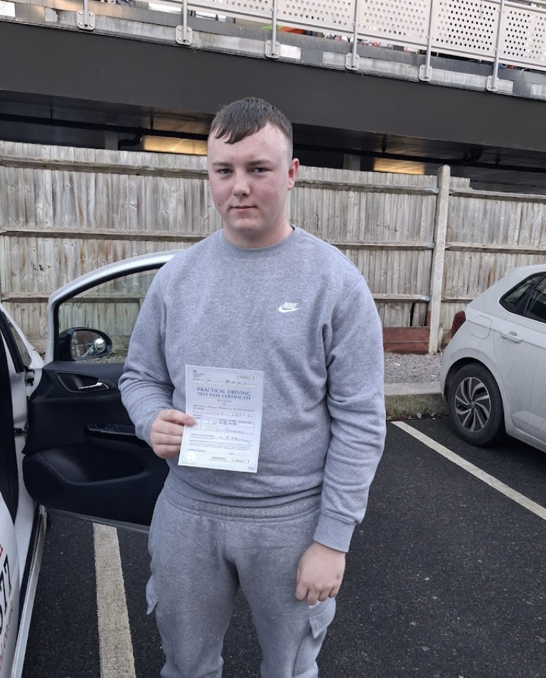 Student in grey hoodie with pass certificate