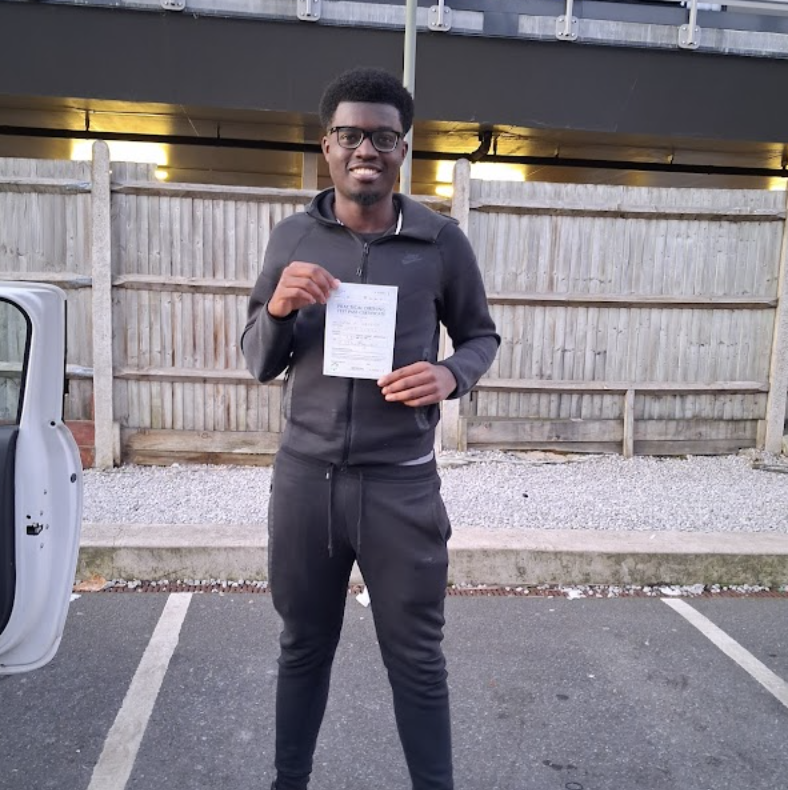 Student with pass certificate at test centre