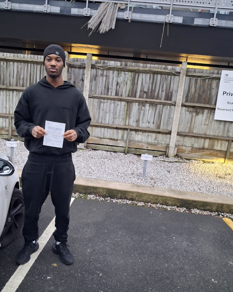 Student in black tracksuit with pass certificate